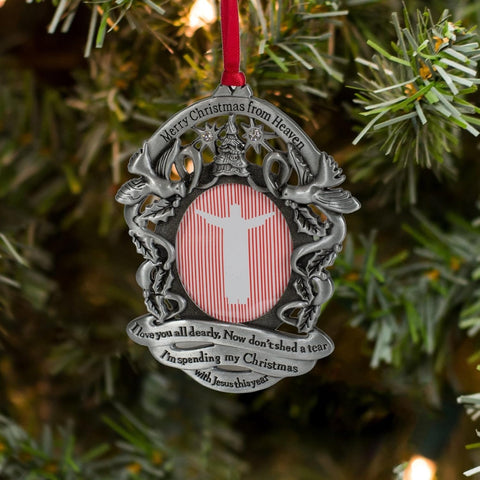 Merry Christmas From Heaven ornament next to a hand for scale, compact keepsake