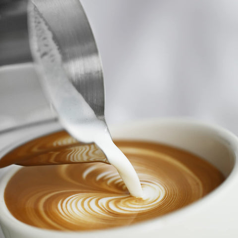 MHW-3BOMBER pouring latte art into cup showing controlled flow benefit