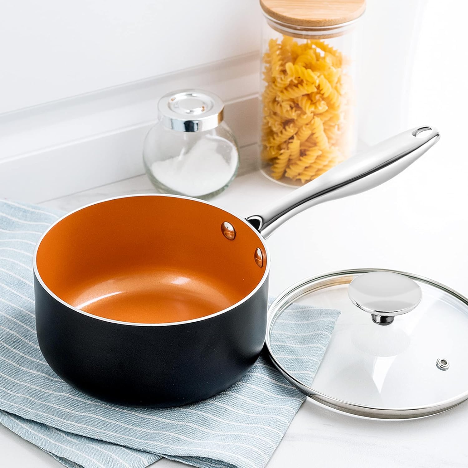 MICHELANGELO saucepan next to spoon showing 3 quart size for everyday cooking
