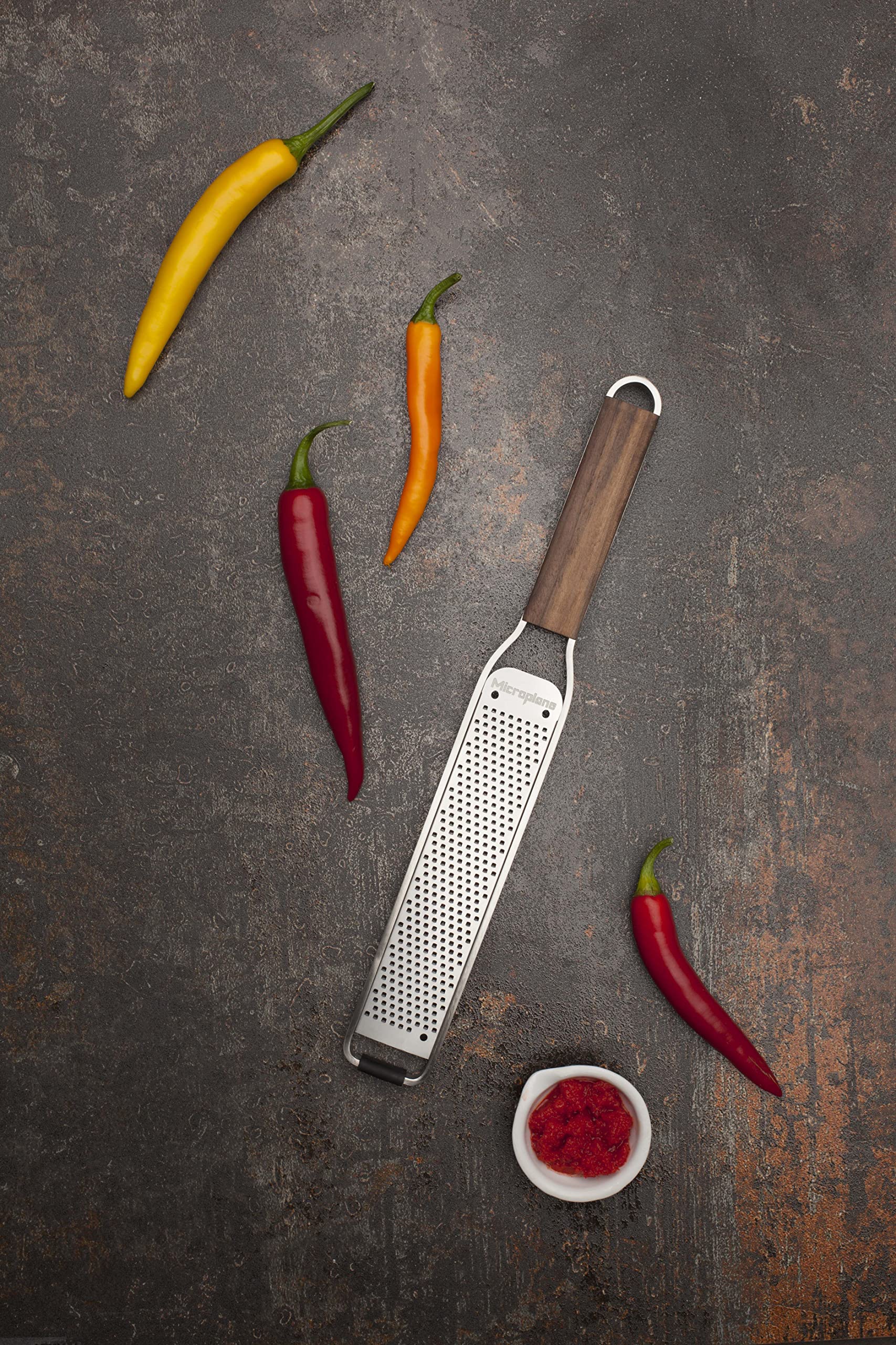 Microplane scale comparison next to kitchen knife shows compact size