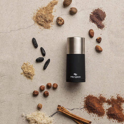 Microplane mill on kitchen counter next to cup and spices for culinary inspiration