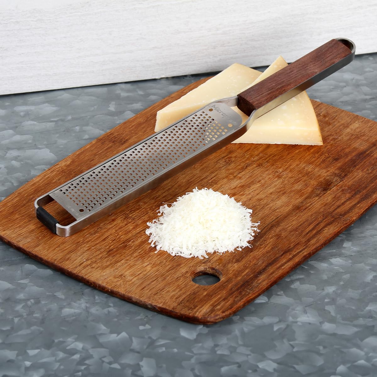 Microplane zester in use zesting lemon for bright citrus flavor