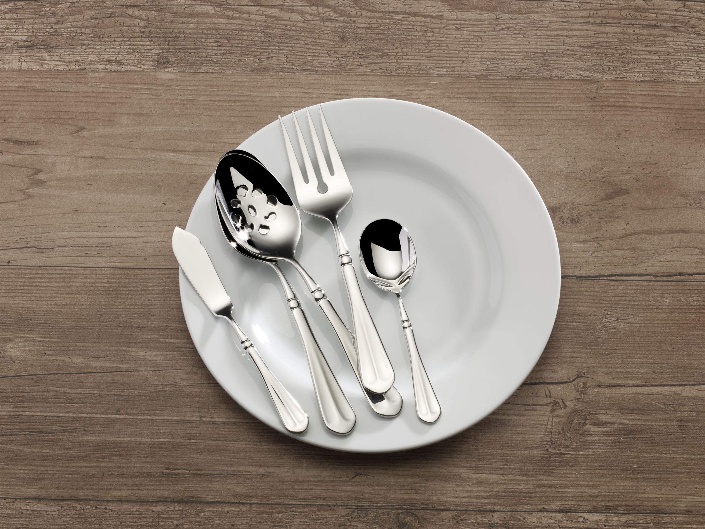 Mikasa table set for 12 showing cohesive flatware with varied dinnerware for versatile styling