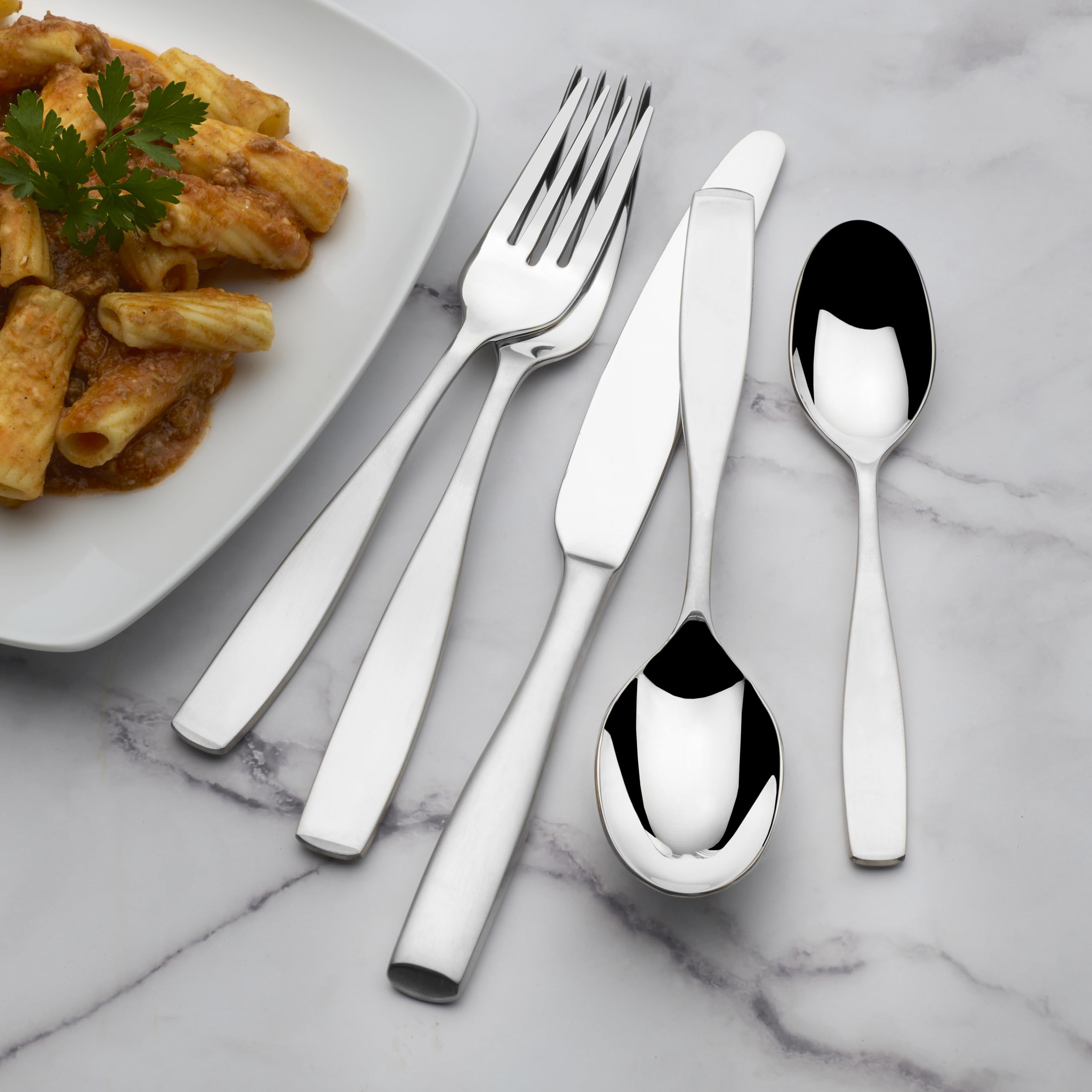 Mikasa flatware styled on a dining table in a living room setting conveying elegant everyday use