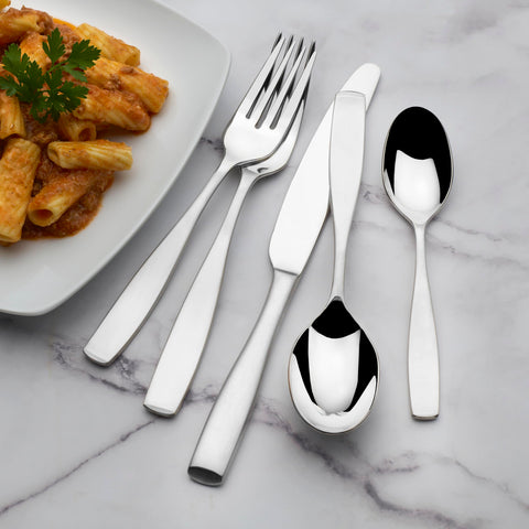Mikasa flatware styled on a dining table in a living room setting conveying elegant everyday use