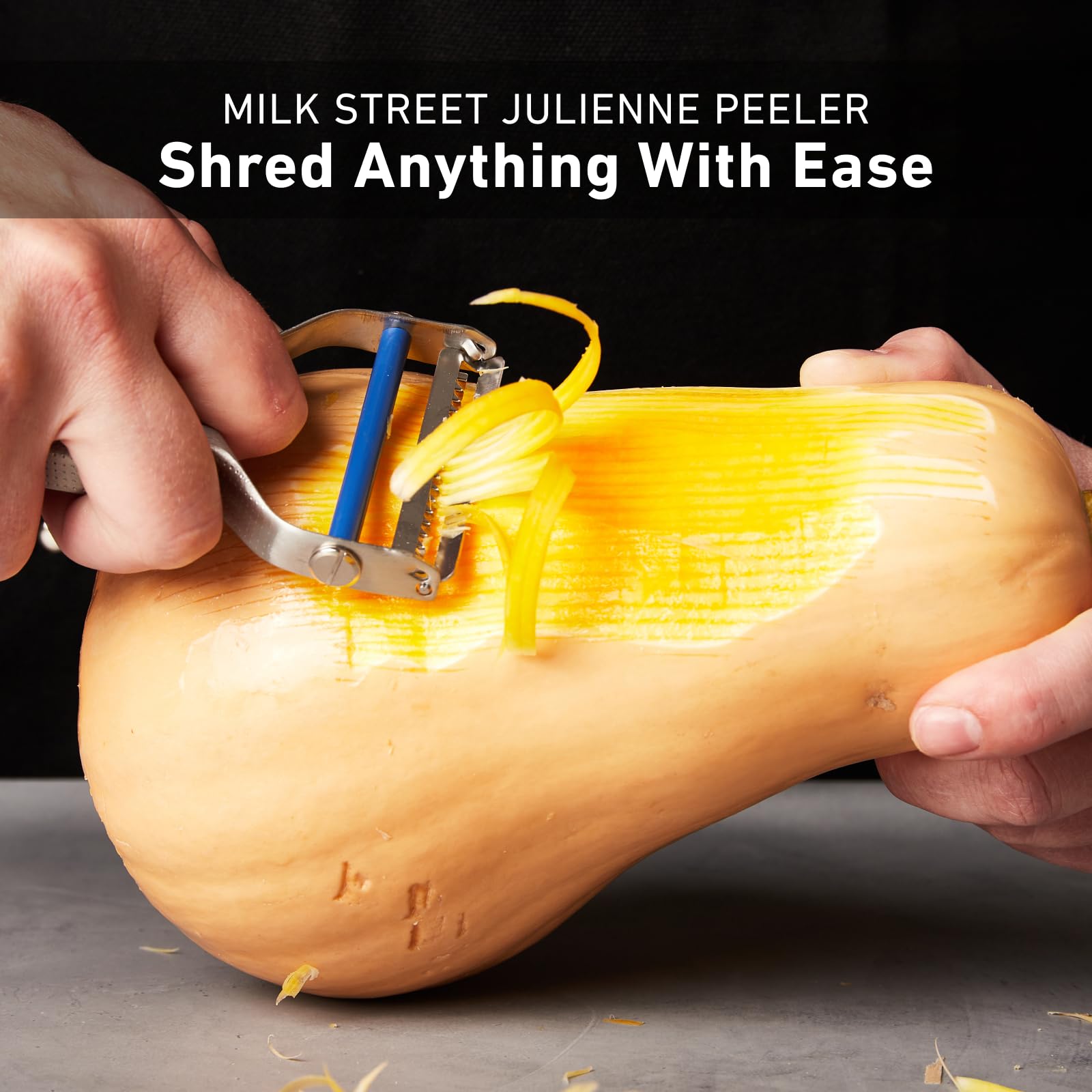 Milk Street julienne peeler next to replacement blade packet for easy maintenance and longevity