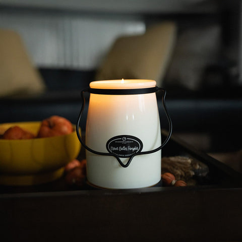 Milkhouse Candle Company candle on coffee table adding cozy home ambience