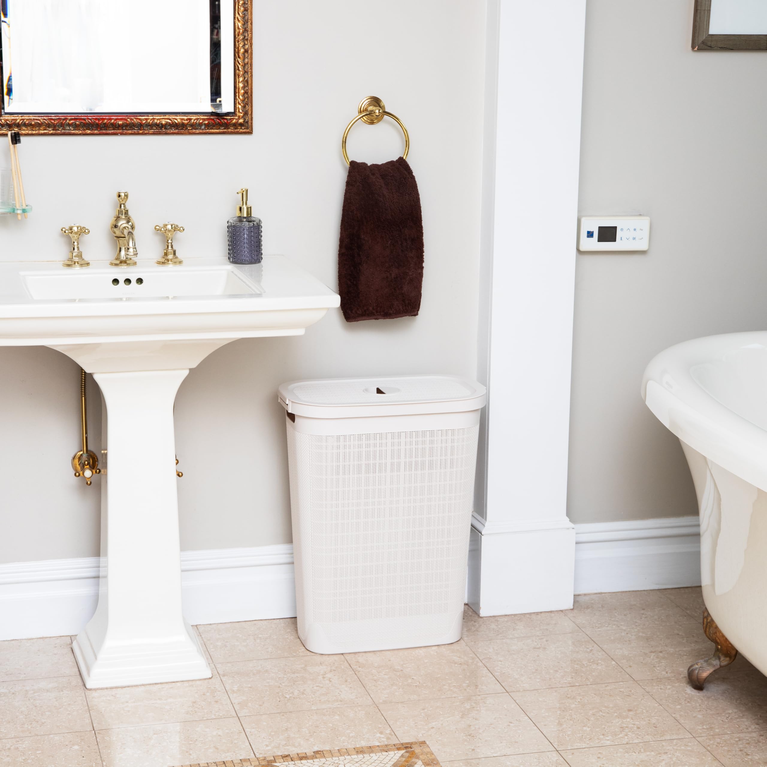 Mind Reader hamper next to laundry machine showing size and space-saving fit