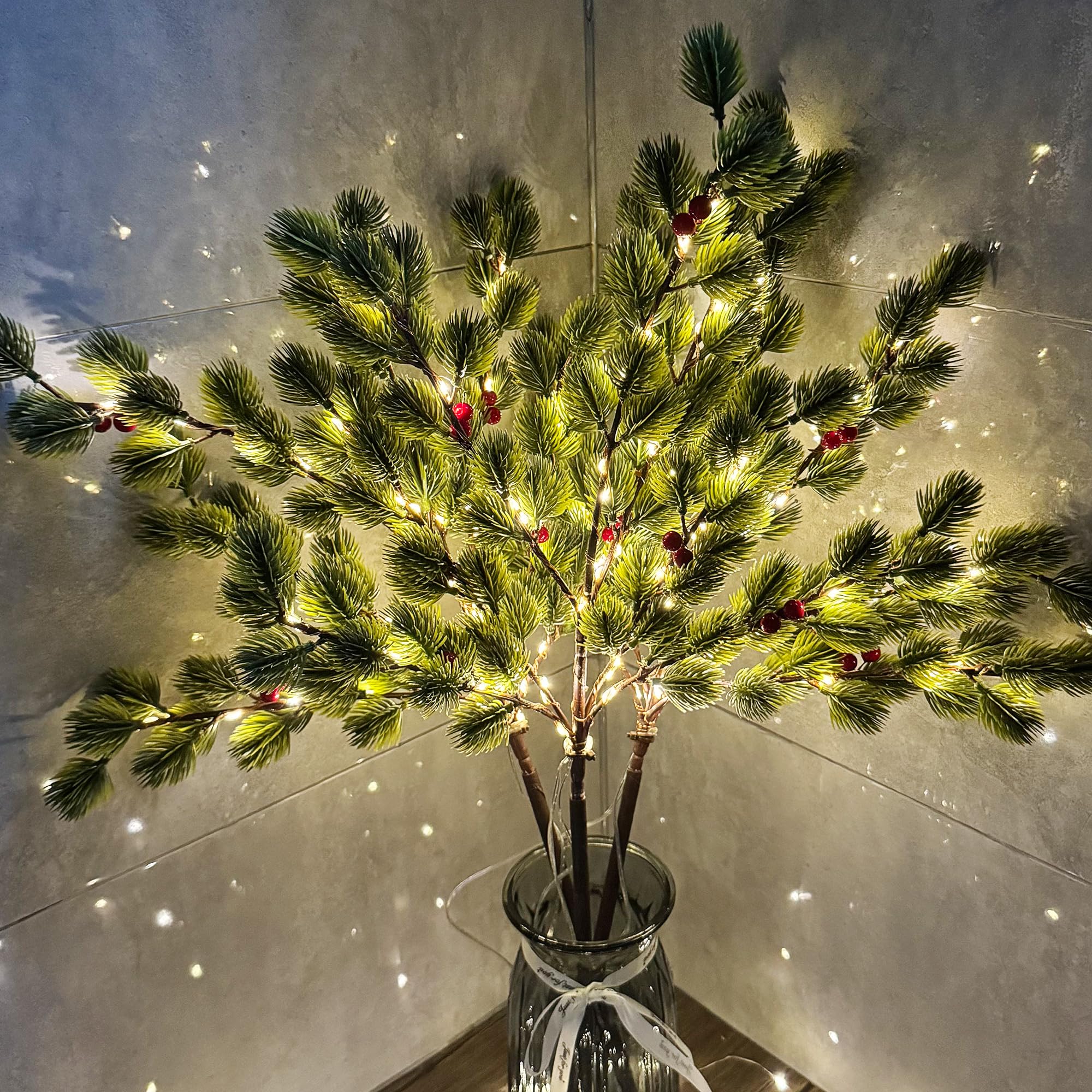 MINDELF porch display at night with branches adding warm holiday glow