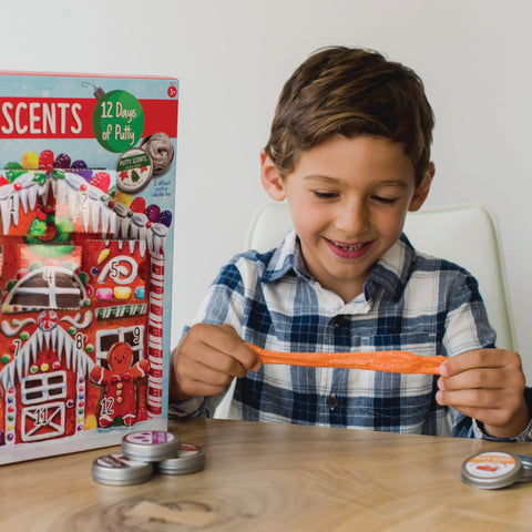 MindWare tins tucked into a backpack, emphasizes easy travel and on-the-go fun