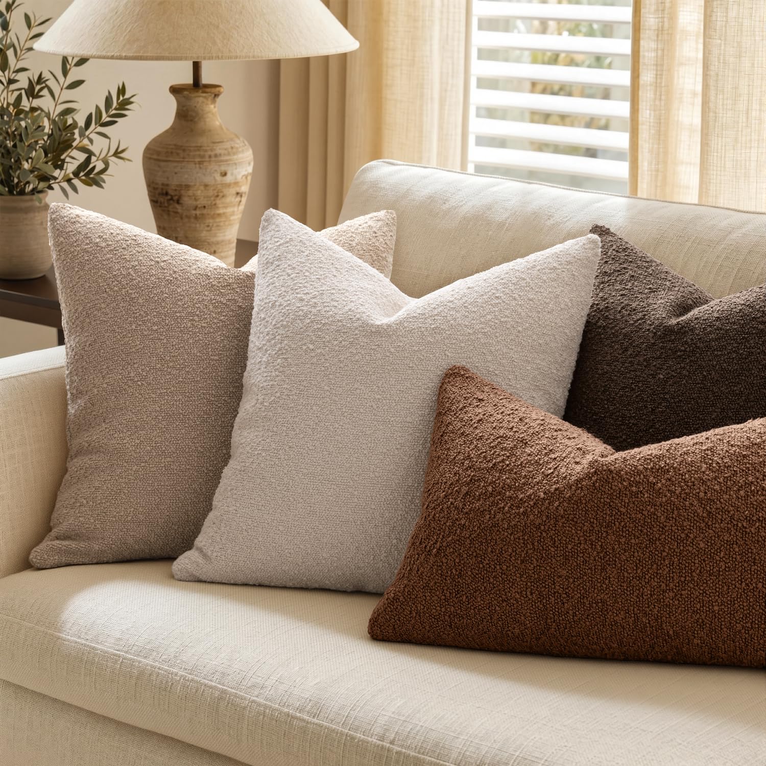 MIULEE styled on sofa with throw demonstrating cozy layered living room look