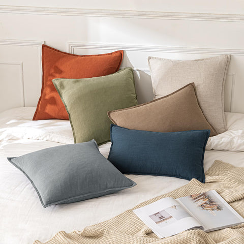 MIULEE on sofa in living room adding cozy neutral layering and styling benefit