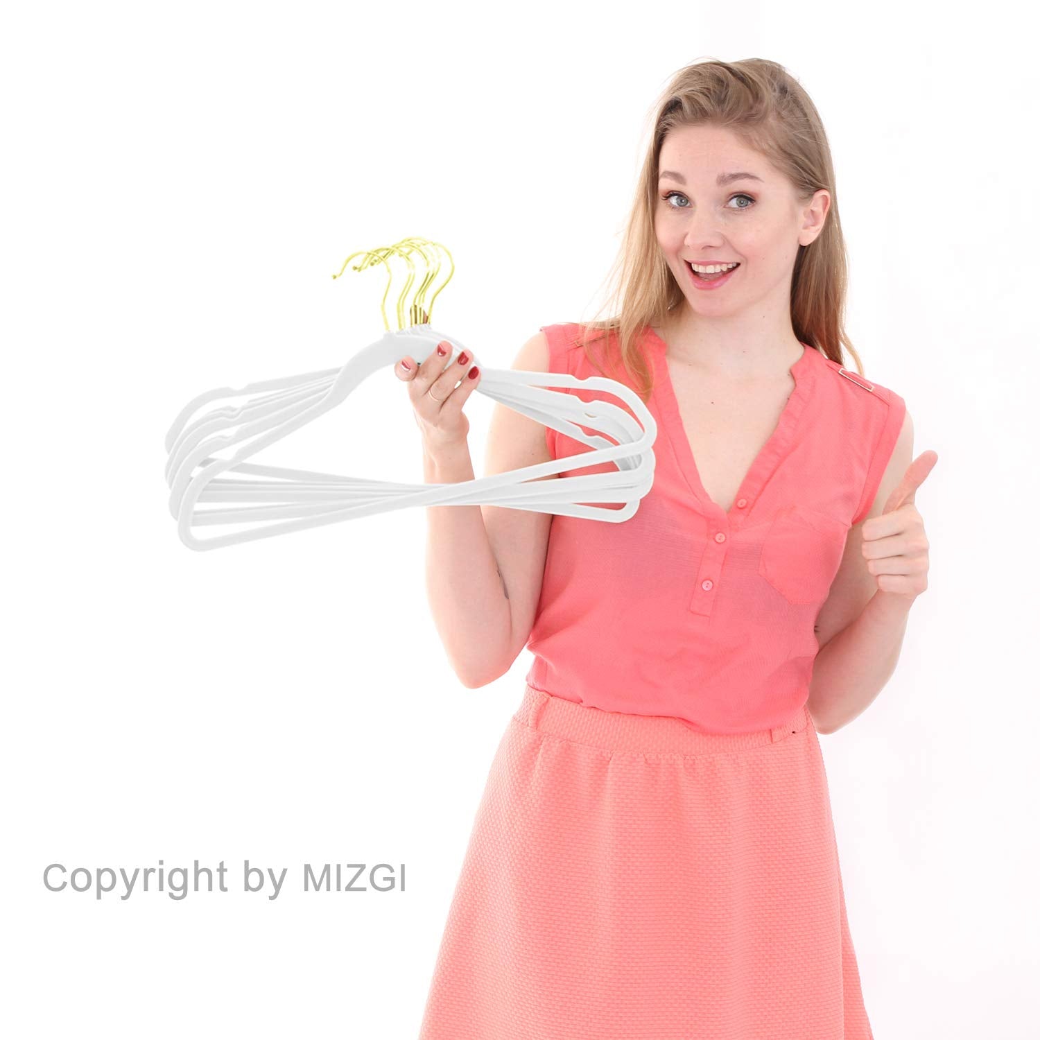MIZGI hanger next to hand showing slim profile for maximizing closet space
