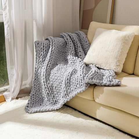 MocaDng throw beside a chair to show 40x40 inch size and portability