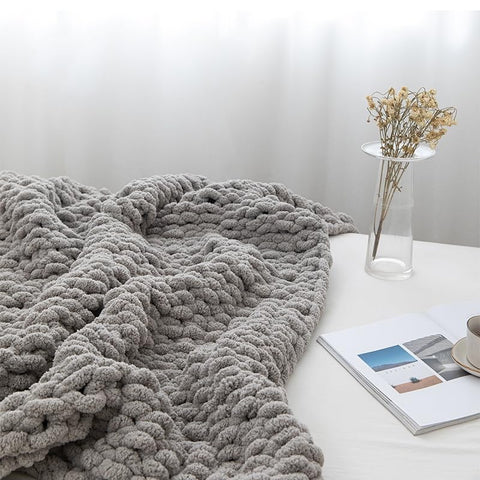 MocaDng blanket next to person showing generous 48x71 inch size