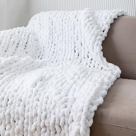 MocaDng throw draped over couch adding warmth and decorative texture to living room