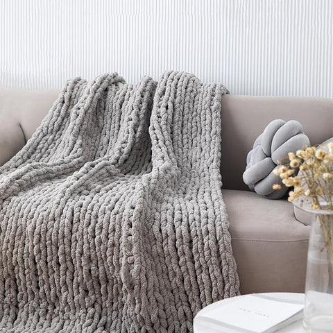 MocaDng blanket draped on sofa adding warmth and visual appeal