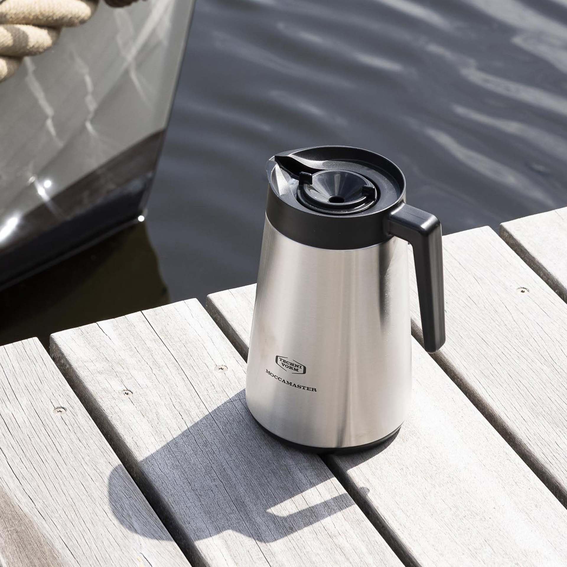 Moccamaster carafe in kitchen setting offering hot coffee for gatherings