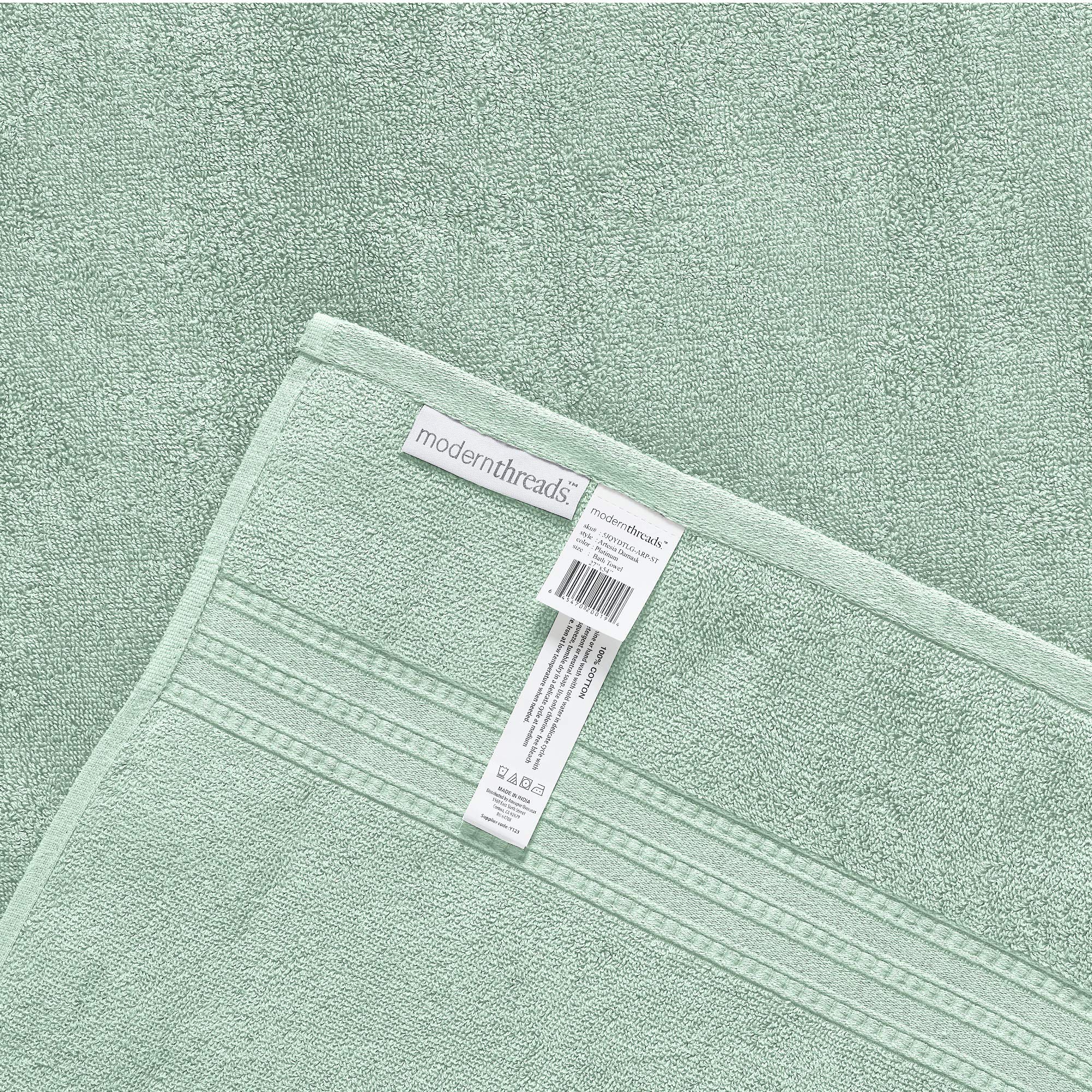 Modern Threads folded towels on shelf in styled bathroom adding color and coordinated design