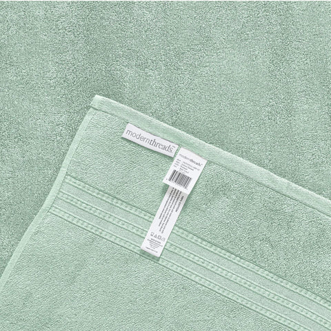 Modern Threads folded towels on shelf in styled bathroom adding color and coordinated design