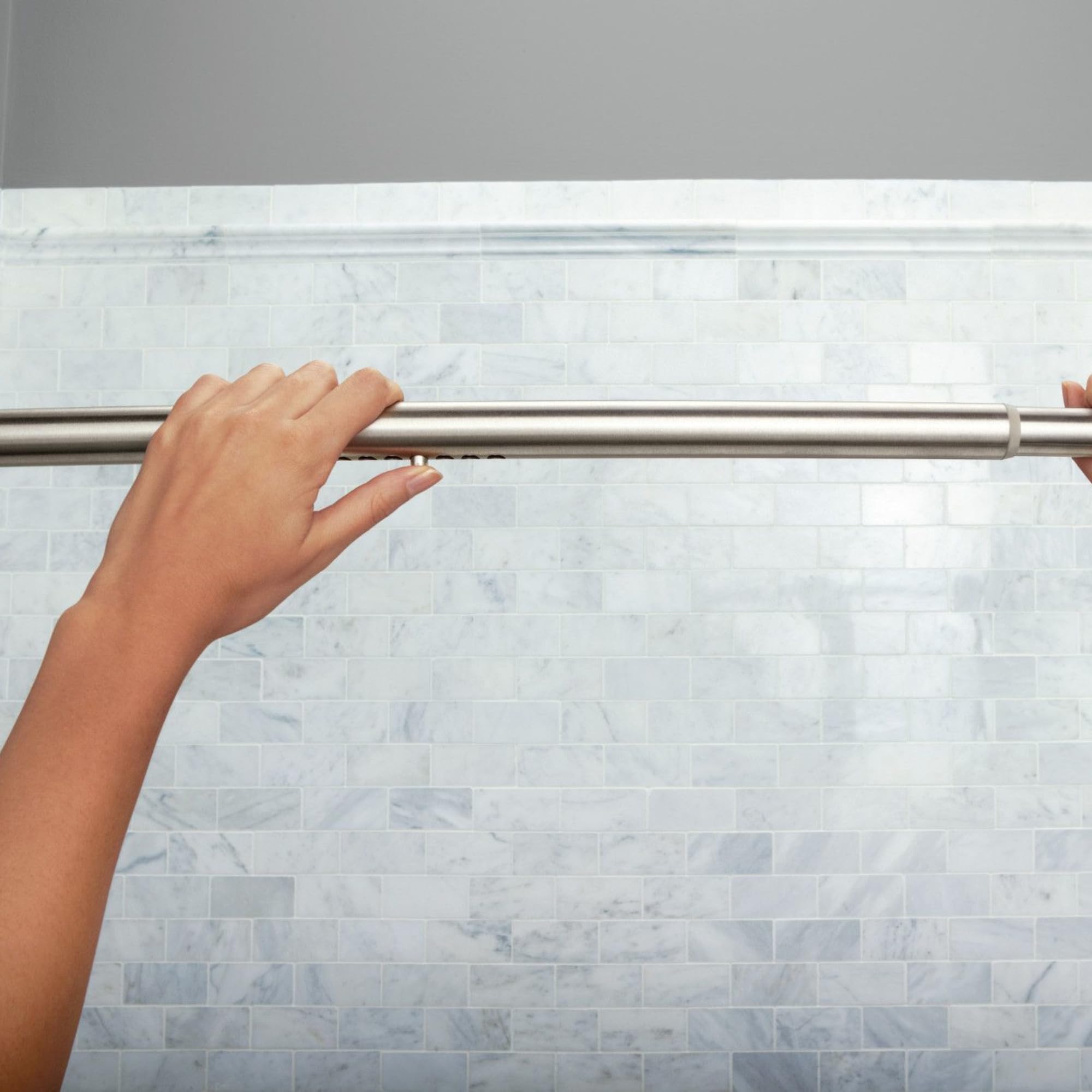 Moen rod installed over tub showing increased shower space benefit