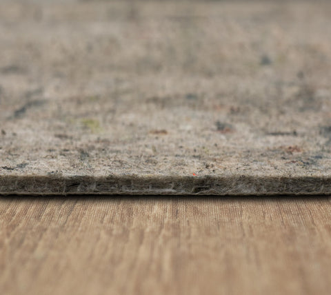 Mohawk Home pad shaken outside during cleaning for easy care