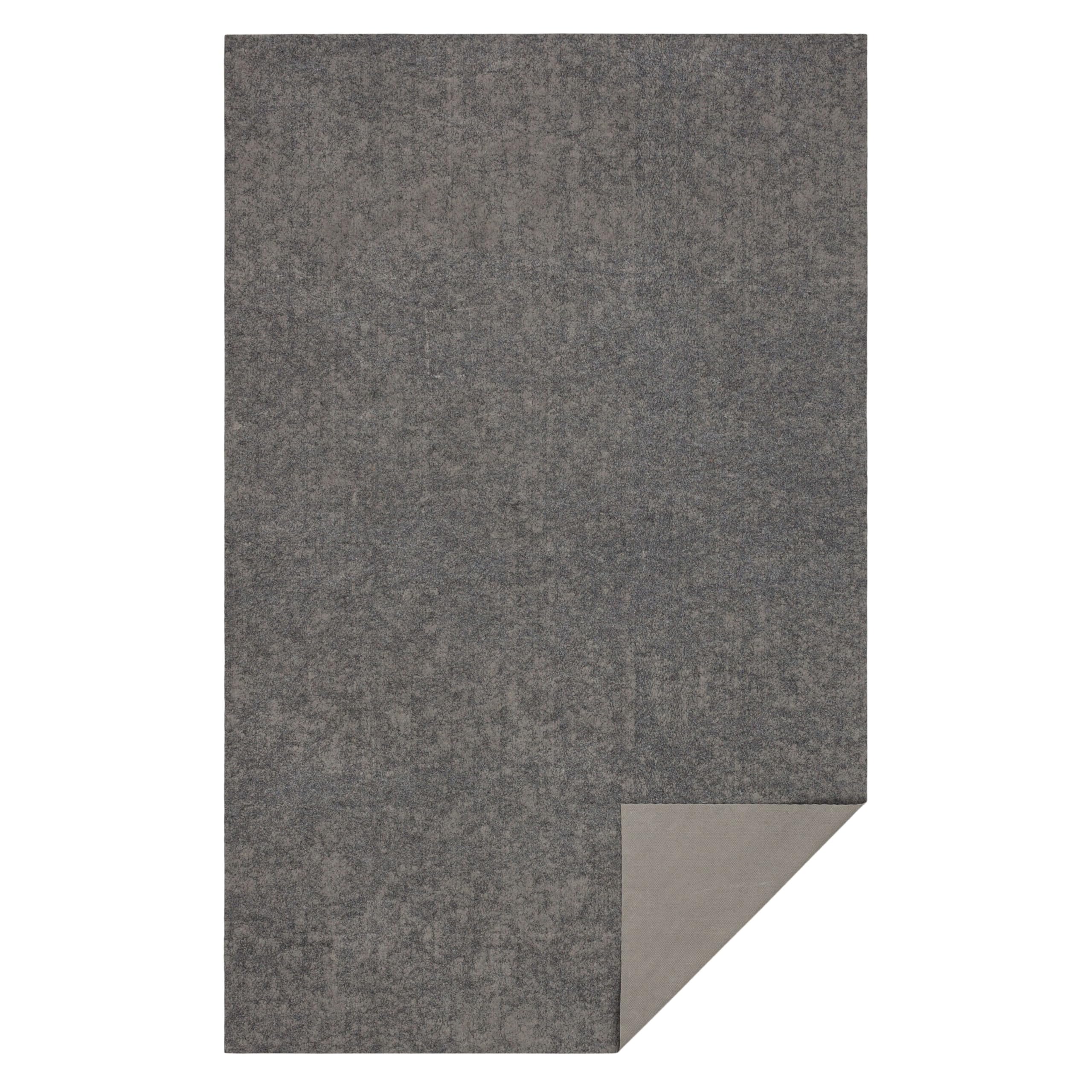 Mohawk Home rug pad next to ruler showing scale for accurate sizing