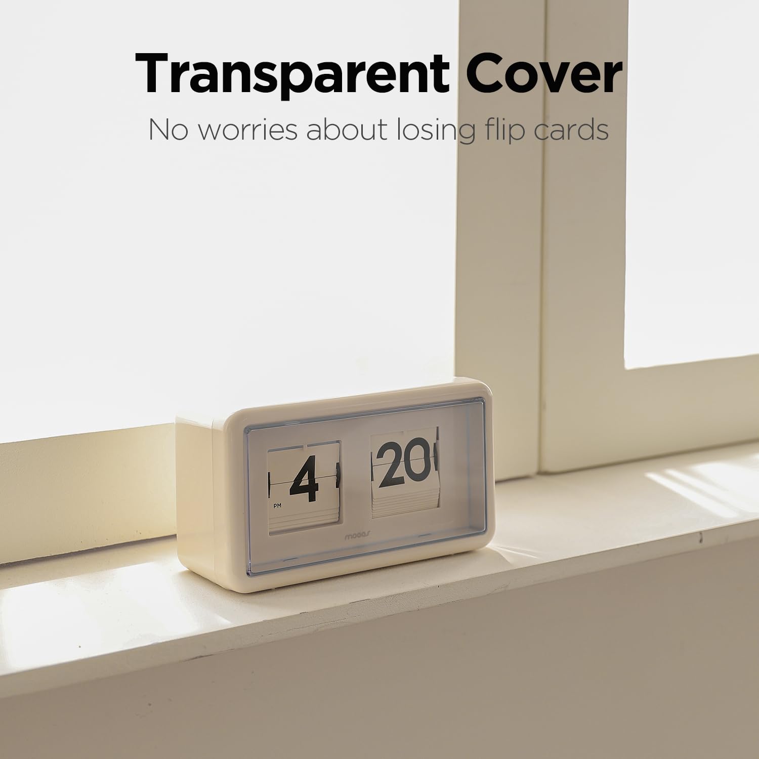 mooas flip clock next to book for scale showing compact footprint and balance