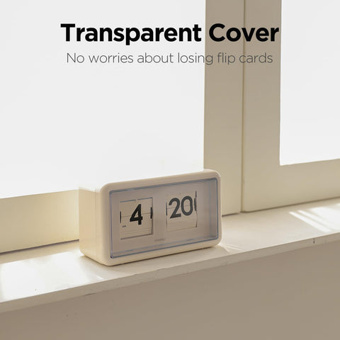mooas flip clock next to book for scale showing compact footprint and balance