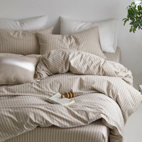 MooMee styled bedroom with striped duvet creating calm resort-inspired vibe