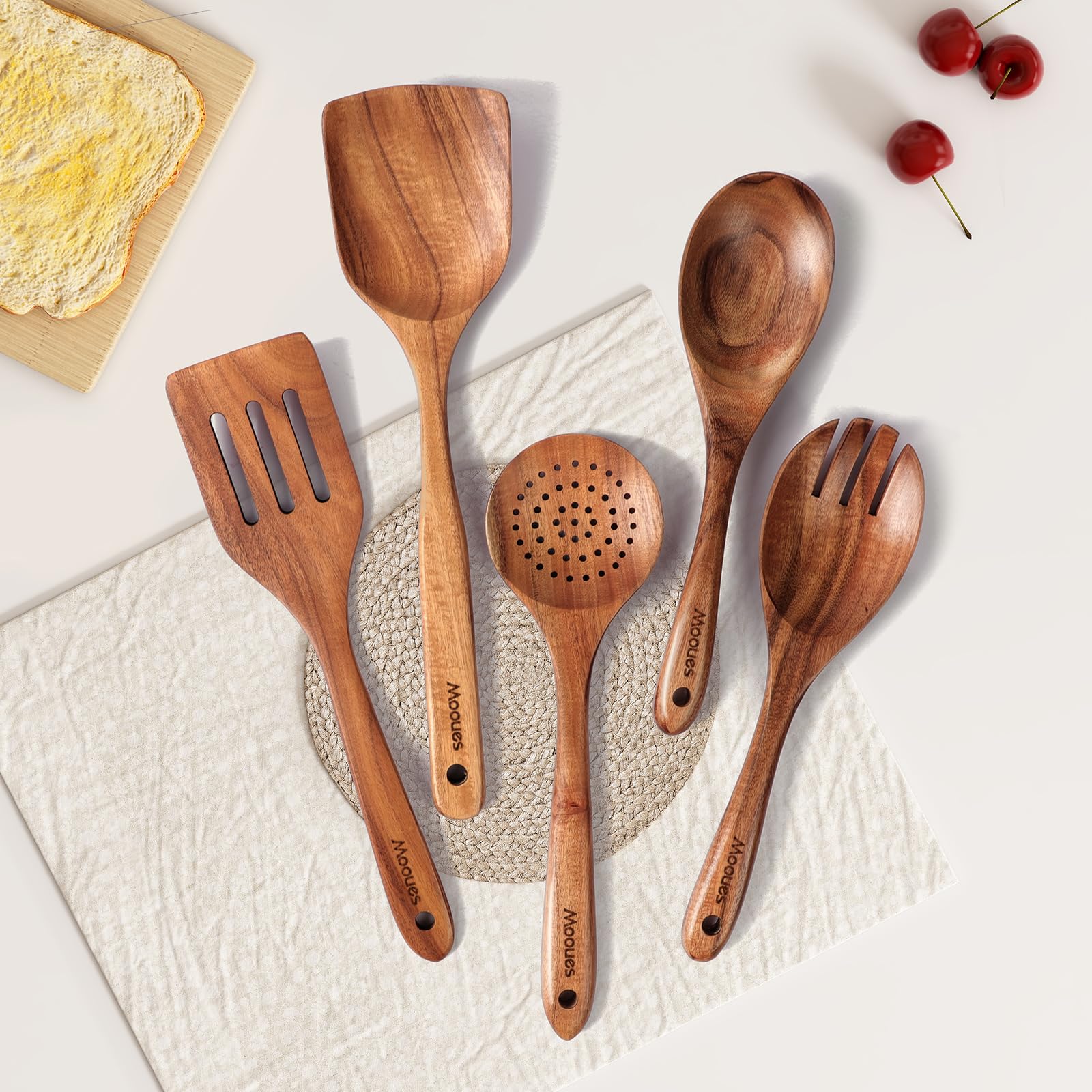 Mooues utensils on countertop beside wooden bowl showing natural aesthetic and display appeal