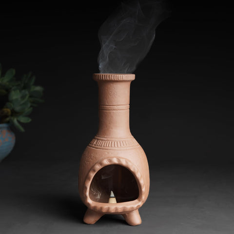 MOUGIGI tealight placed inside chiminea showing warm glow and secure ash basin
