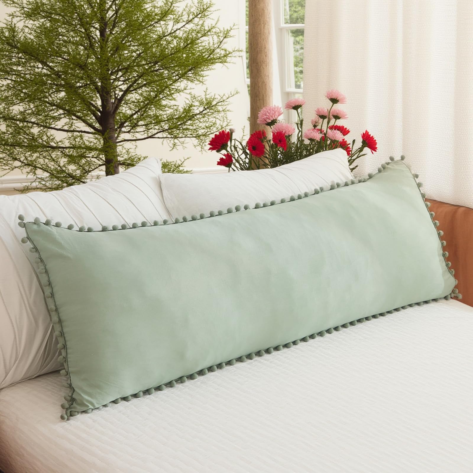 MOVE OVER front view of sage green body pillow cover shows full pom-pom trim and calm color