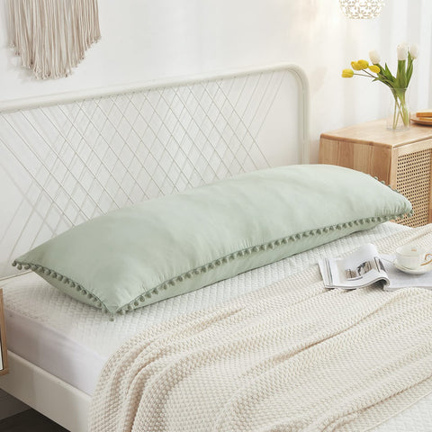 MOVE OVER close-up of pom-pom fringe highlighting handcrafted texture and decorative detail