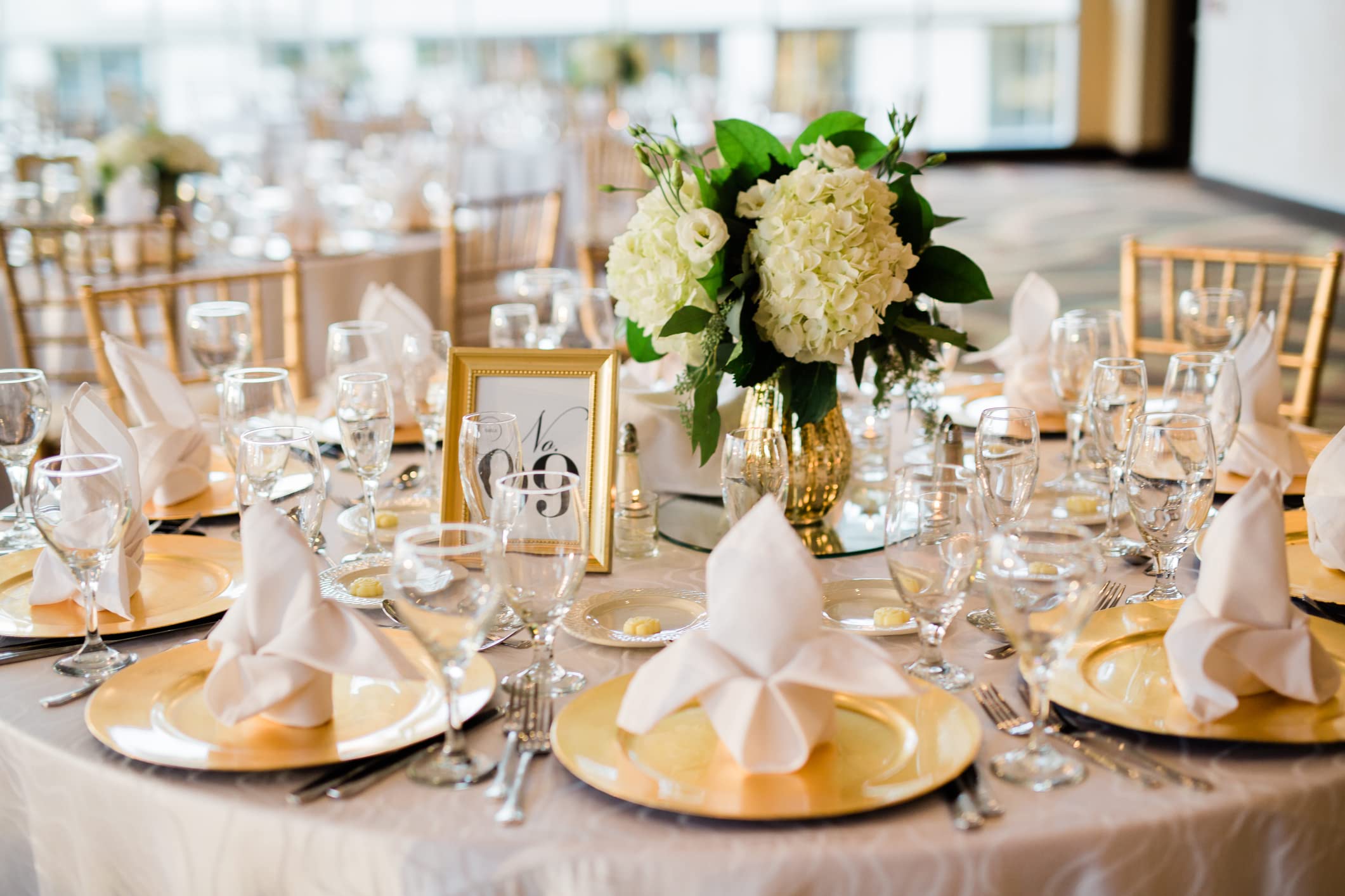 Ms Lovely silver charger plate styled at a wedding table to enhance place settings and décor
