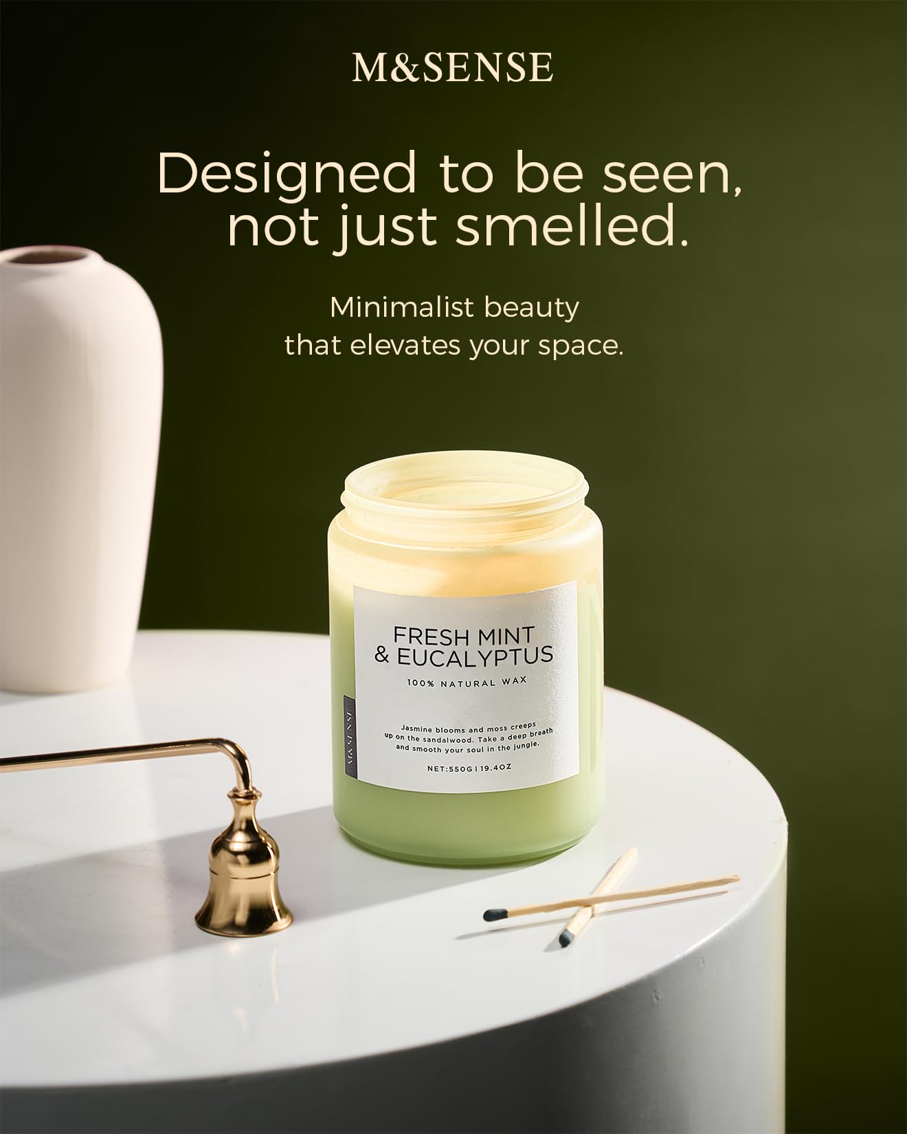 M&SENSE candle beside coffee mug showing scale and generous 19.4 oz capacity
