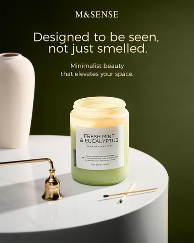 M&SENSE candle beside coffee mug showing scale and generous 19.4 oz capacity