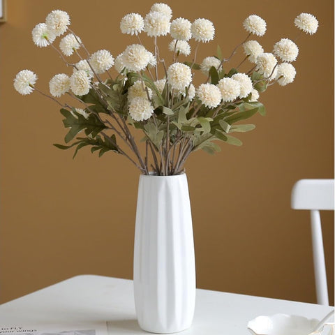 MSIUE hands arranging stems in a vase showing easy shaping and customization