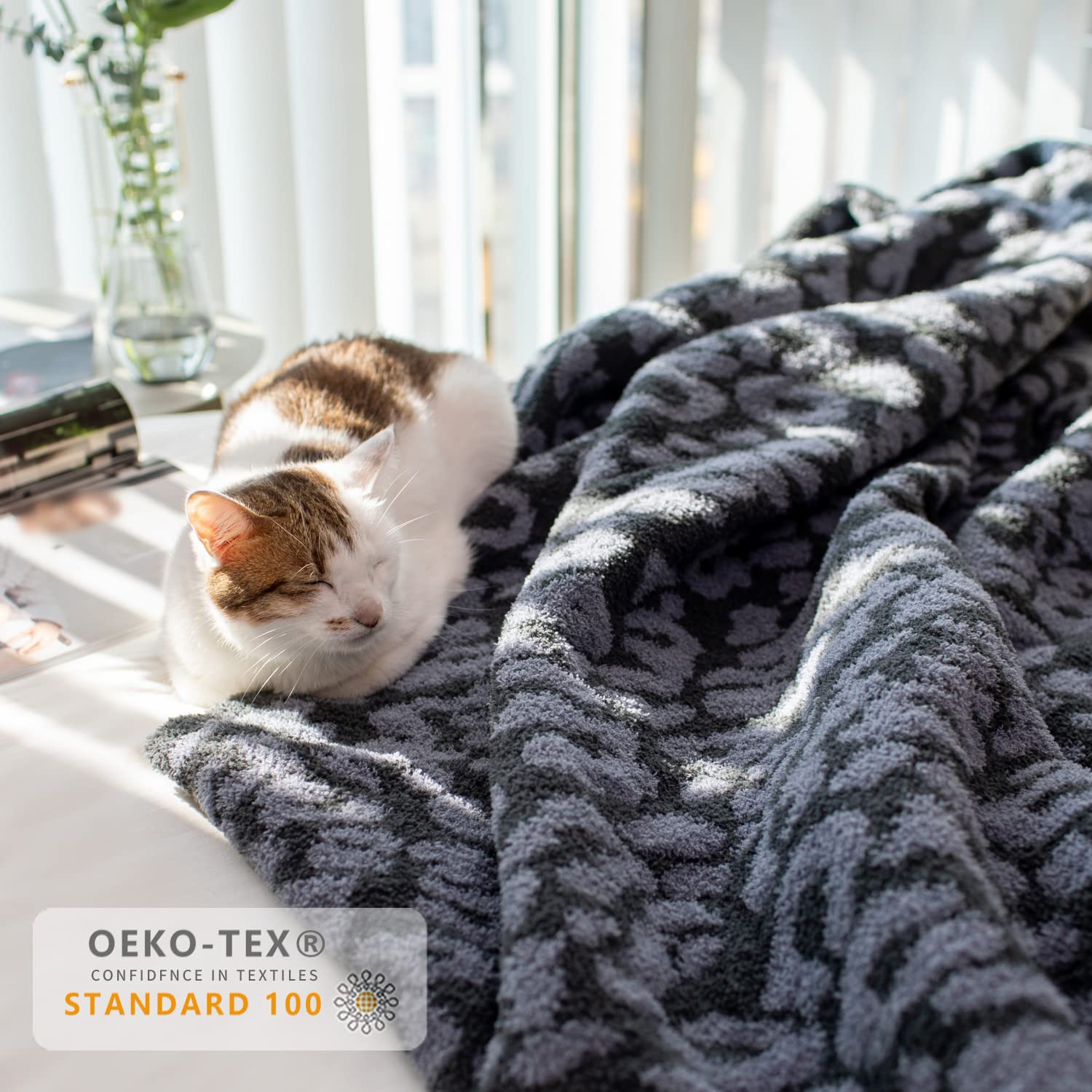 MH MYLUNE HOME draped over bed illustrating full coverage and modern charcoal-blue pattern