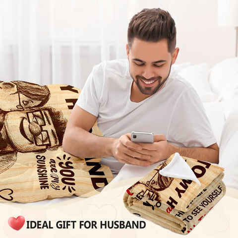 NAIREG blanket draped on couch with husband using it for relaxation