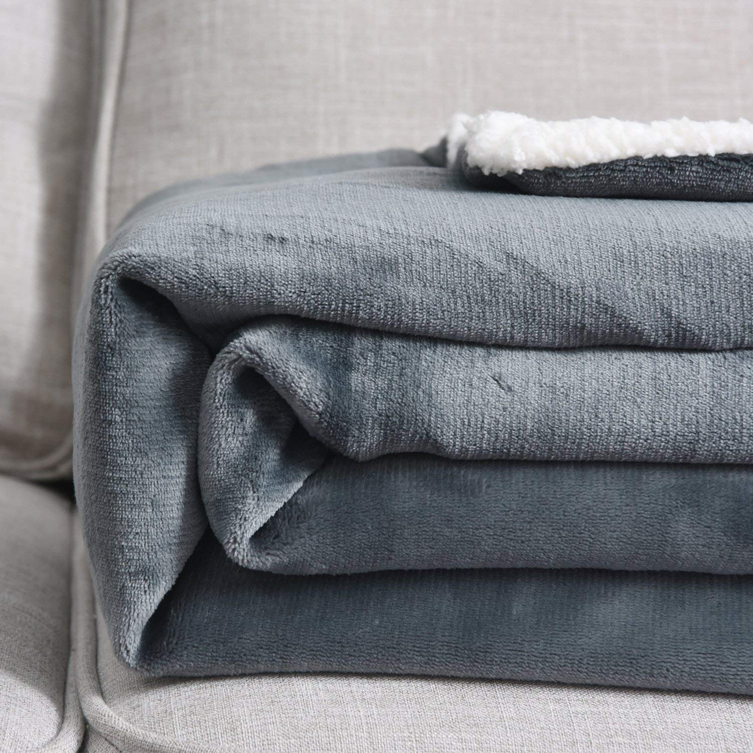 NANPIPER draped on couch in living room offering cozy decor