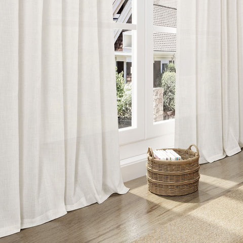 Nanspring curtains beside sofa showing 108-inch length for tall windows