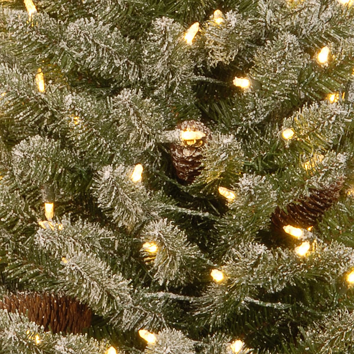 National Tree Company tabletop display of mini tree lit with warm LEDs offering cozy decor without cords