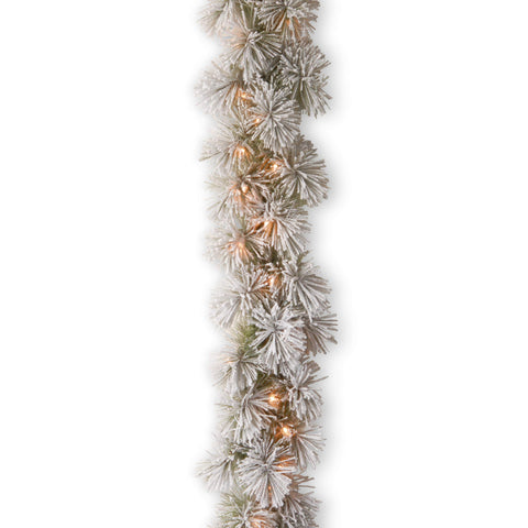 National Tree Company 9ft garland front view showing full snowy volume and bright lights
