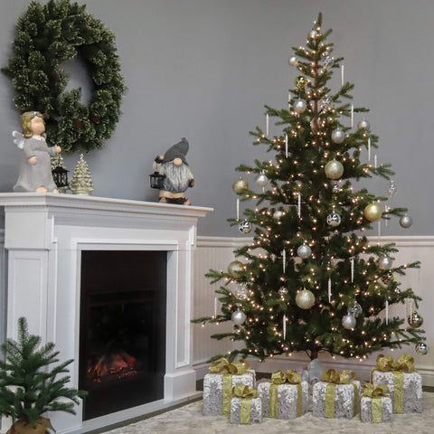 National Tree Company hands fluffing branches during setup showing easy assembly and shaping benefit