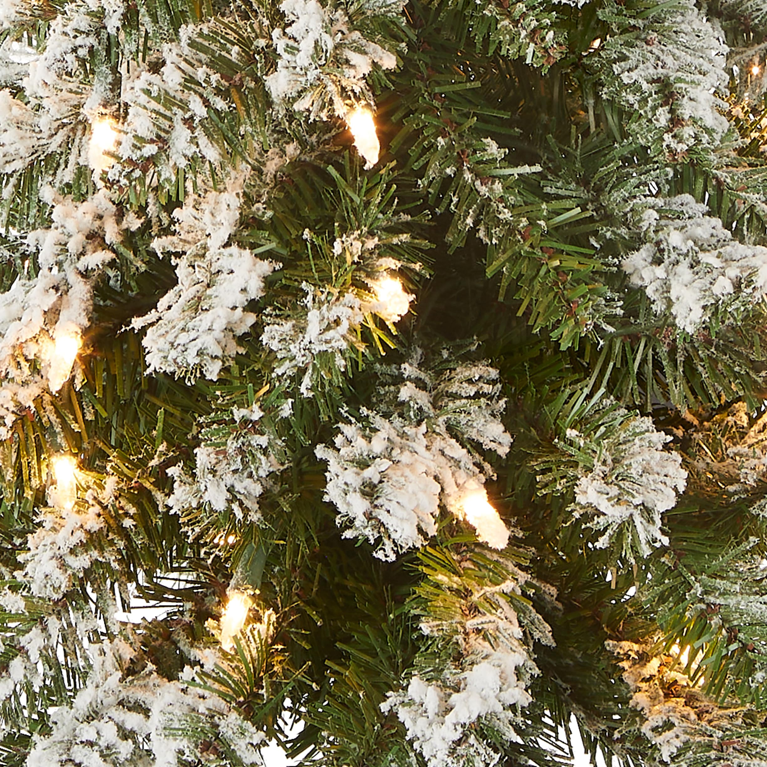 National Tree Company close-up of flocked branch tips highlighting lifelike texture and soft snow effect