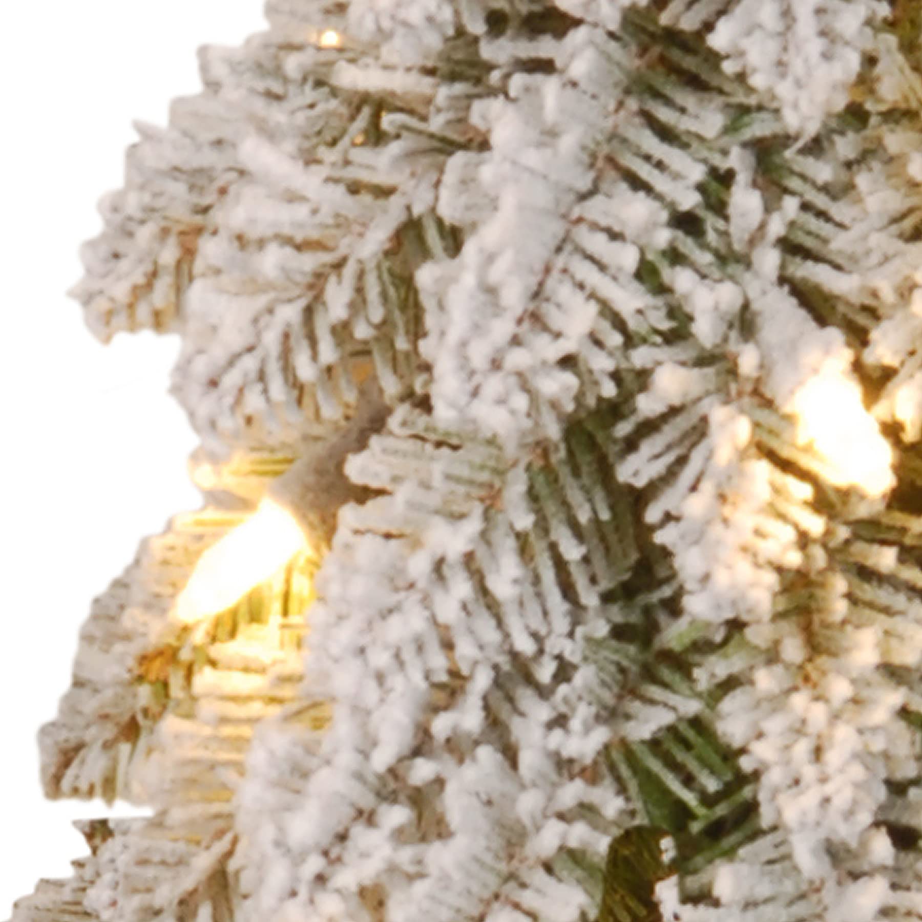 National Tree Company mini tree lit on a side table offering warm white light and cozy holiday atmosphere