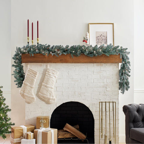 National Tree Company garland lit on mantel with warm white lights, creates cozy ambiance