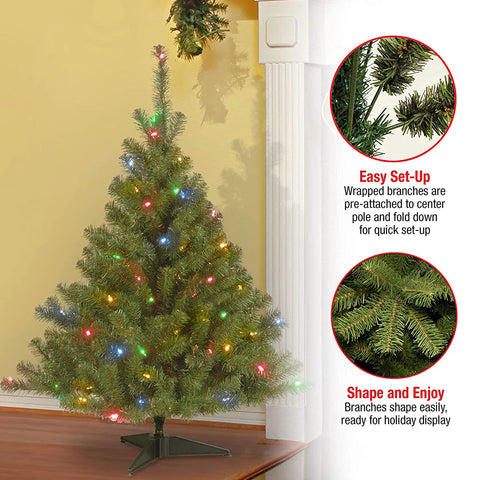 National Tree Company Kincaid Spruce in room setting demonstrating compact fit and ambience
