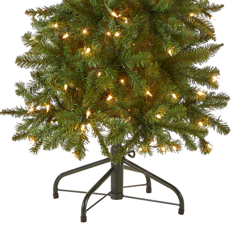 National Tree Company lit tree in living room showing cozy ambiance and space-saving benefit